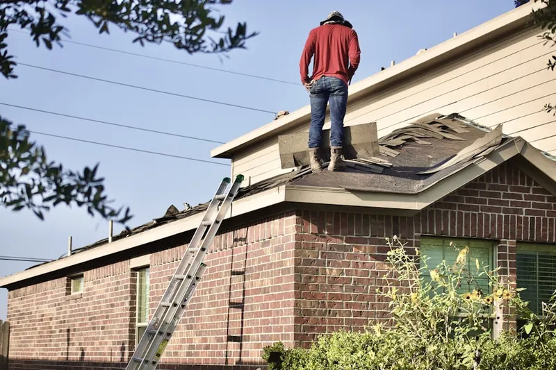 Professional roofer working on a residential roof in Grandy